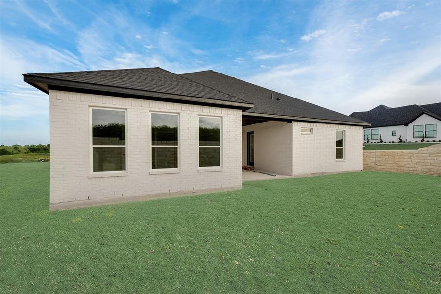 Back of property with a yard and a patio area