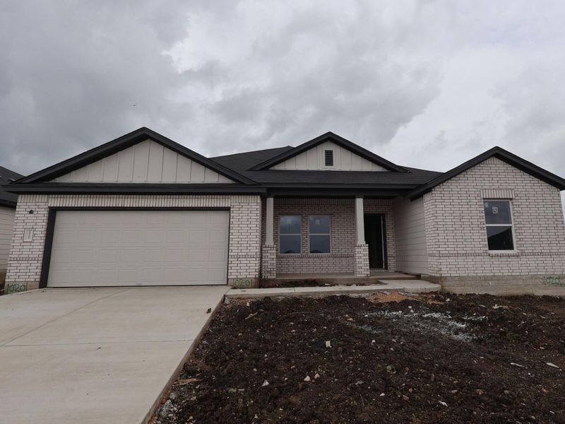 Front exterior of a new home in Willow Springs, Buda, TX, highlighting curb appeal (Image 1). Front exterior of a new home in Willow Springs, Buda, TX, highlighting curb appeal (Image 1).