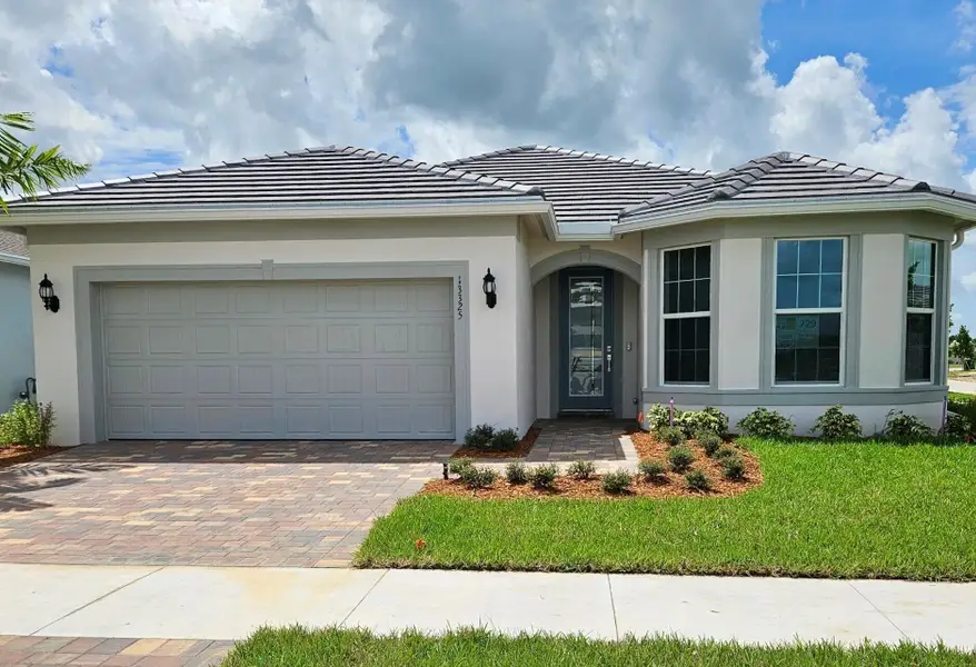 Front exterior of a new home in Del Webb Tradition, Port St. Lucie, FL, highlighting curb appeal (Image 14).