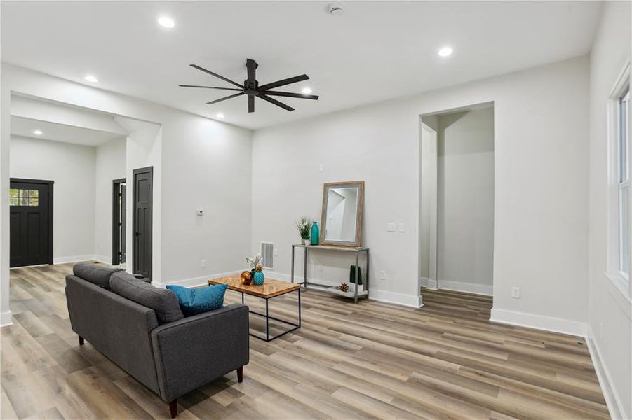 Living room with ceiling fan and light Luxury Vinyl Plank flooring