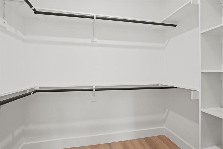 Spacious closet with wood finished floors Spacious closet with wood finished floors