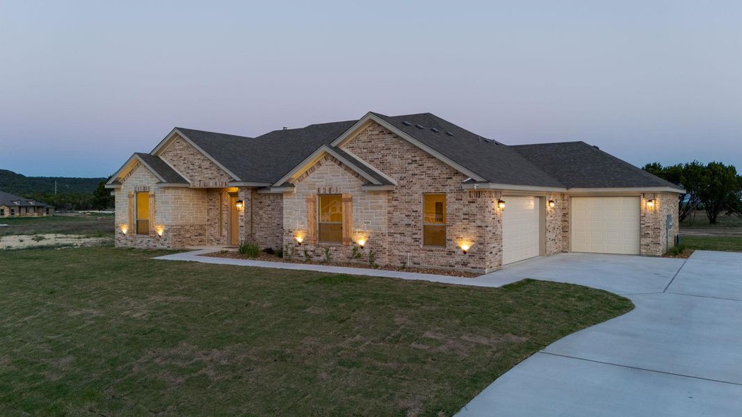 View of front of house featuring brick siding, concrete driveway, and roof with shingles View of front of house featuring brick siding, concrete driveway, and roof with shingles