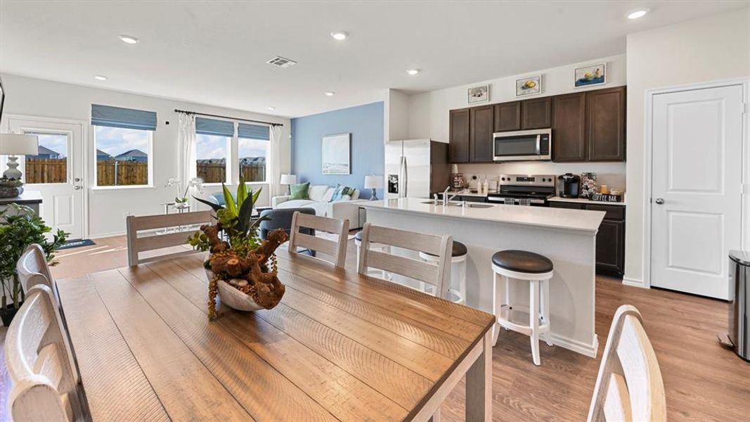 Dining area featuring light wood-type flooring and recessed lighting