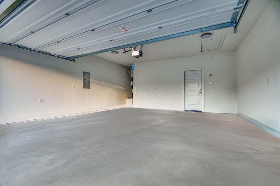 Garage with electric panel and baseboards