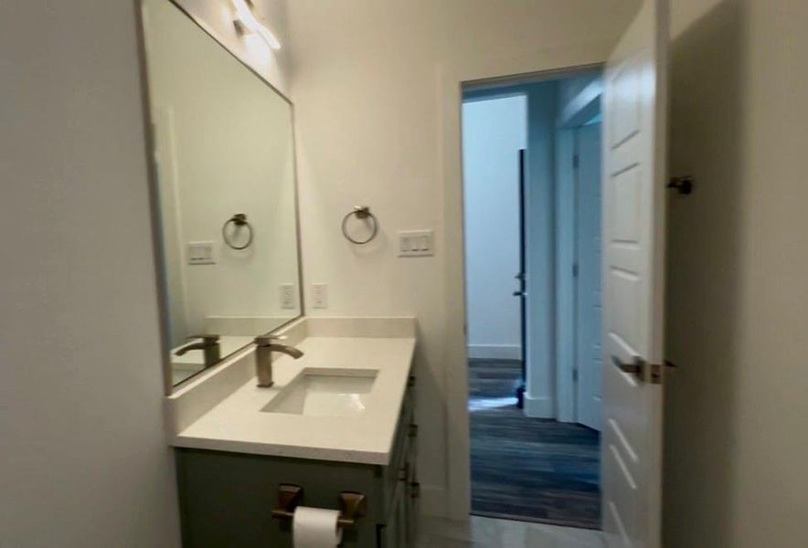 Vanity with a quartz-finish countertop and integrated rectangular sink
