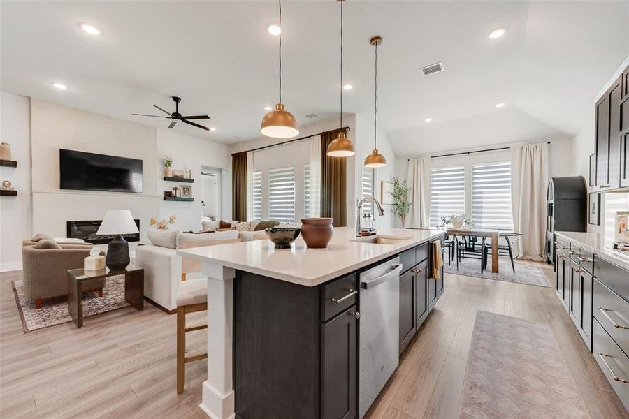 Kitchen island with a light-toned countertop and pendant lighting