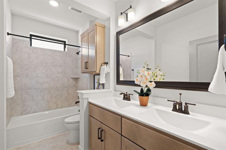 Upstairs secondary Bathroom with a shower/tub combo and double sinks