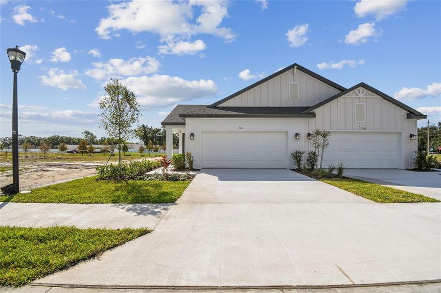 Front exterior of a new home in Fairway Pointe - 55+ Villa Community, Sun City Center, FL, highlighting curb appeal (Image 1).