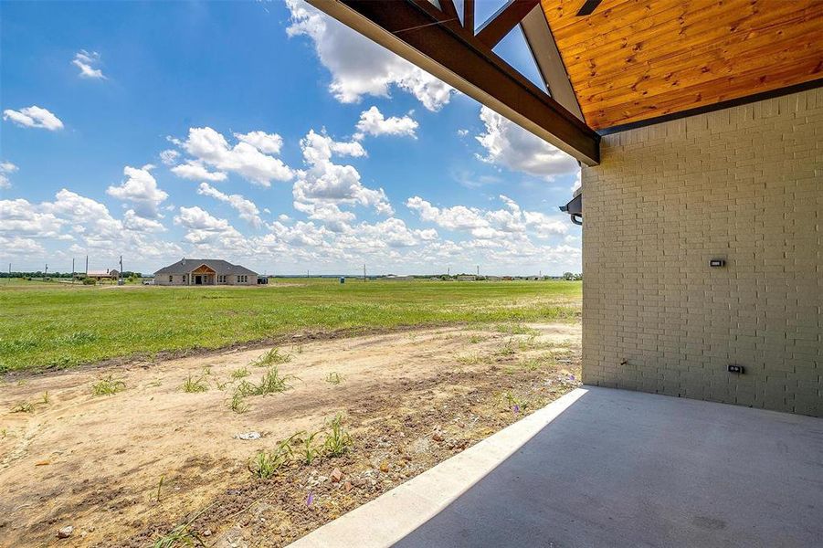 View of yard with a patio and a rural view