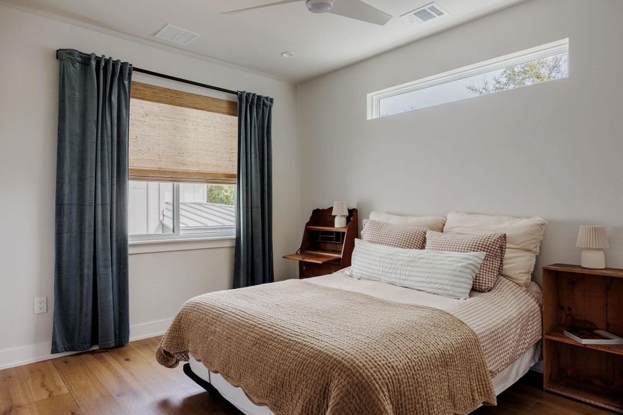 Bedroom featuring wood-type flooring and ceiling fan