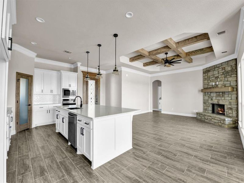 Kitchen featuring visible vents, arched walkways, a sink, and stainless steel microwave Kitchen featuring visible vents, arched walkways, a sink, and stainless steel microwave