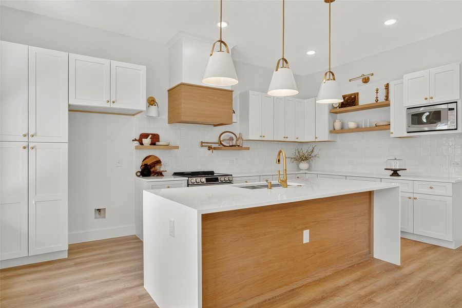 Kitchen with open shelves, light wood-style flooring, white cabinetry, decorative light fixtures, and recessed lighting