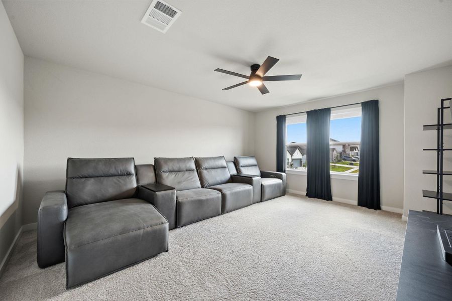 Natural light pours through wide windows onto wall-to-wall carpeting in this versatile living space. Natural light pours through wide windows onto wall-to-wall carpeting in this versatile living space.