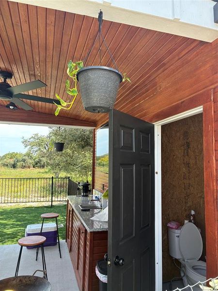 View of patio featuring ceiling fan and a sink