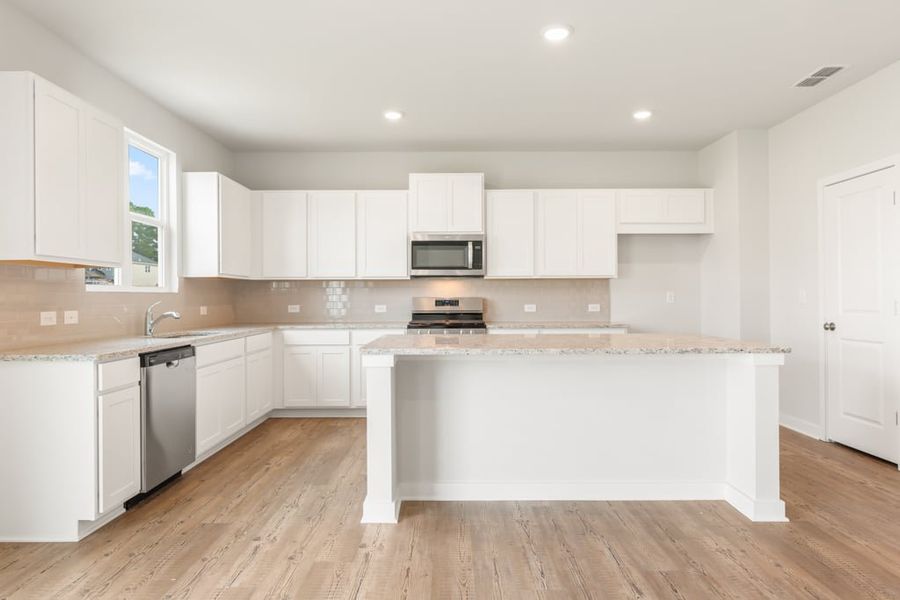 A kitchen with white cabinets. A kitchen with white cabinets.