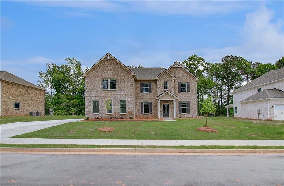 Front exterior of a new home in Cambria at Traditions, Hampton, GA, highlighting curb appeal (Image 23).