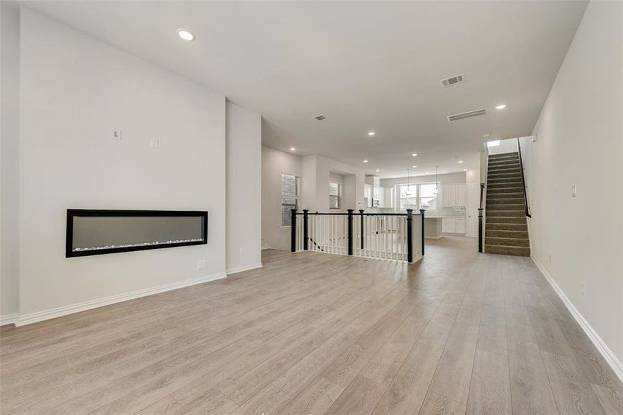 Unfurnished living room with light hardwood / wood-style floors