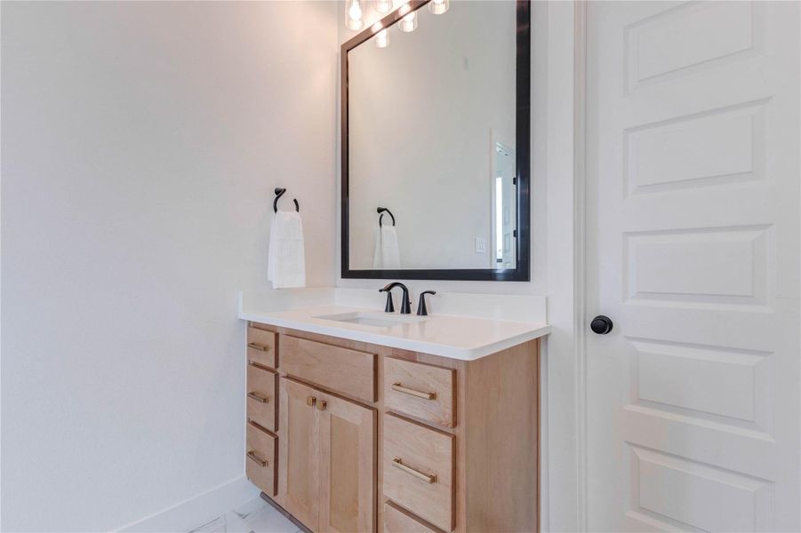 This modern bathroom features a spacious soaking tub, glass-enclosed shower with marble tile, and a double vanity with wooden cabinetry. Bright lighting and sleek fixtures add elegance to the space. This modern bathroom features a spacious soaking tub, glass-enclosed shower with marble tile, and a double vanity with wooden cabinetry. Bright lighting and sleek fixtures add elegance to the space.