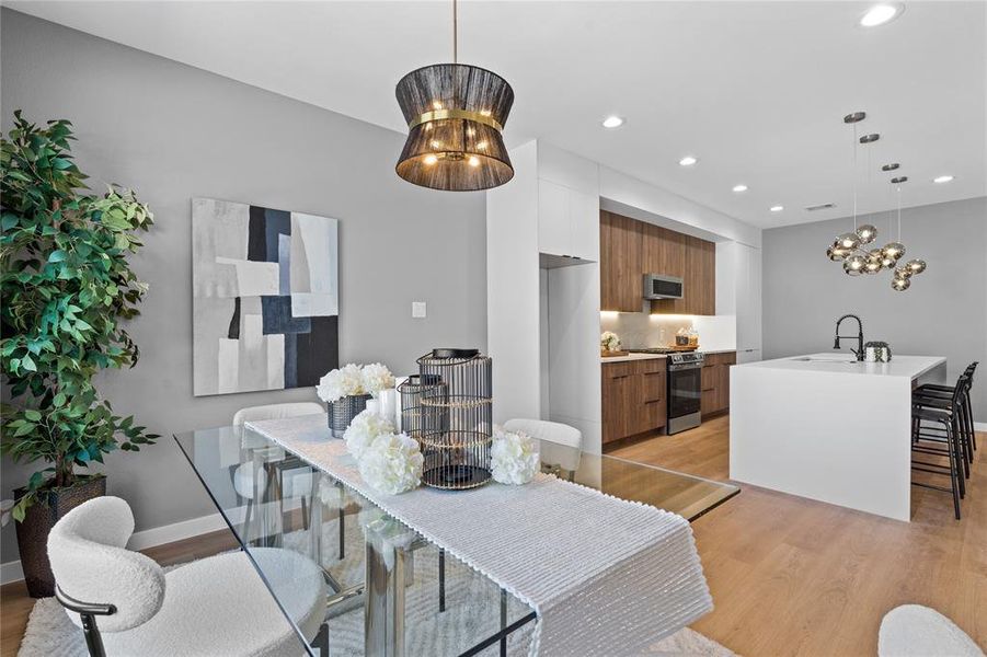 Dining space with light wood-type flooring, a chandelier, and recessed lighting Dining space with light wood-type flooring, a chandelier, and recessed lighting