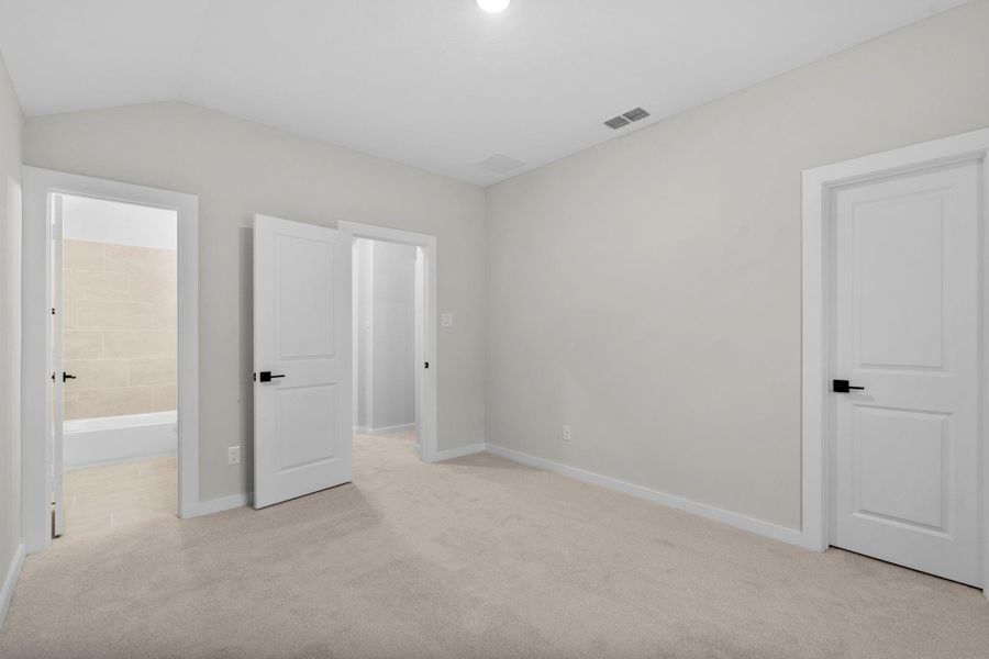 Upstairs bedroom with carpet and a tile bath.