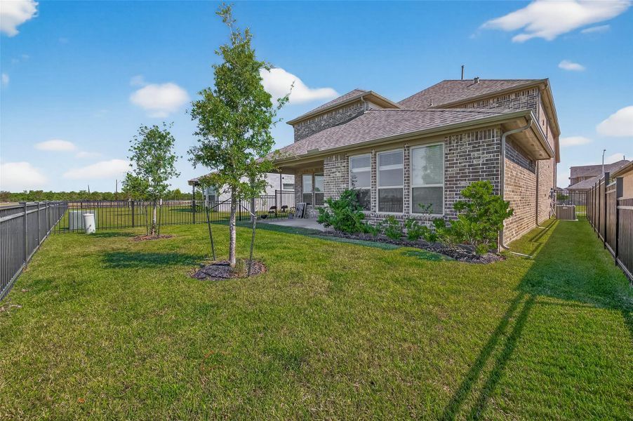 Exterior details and patio area of a home in Sunterra, Katy (Image 26).