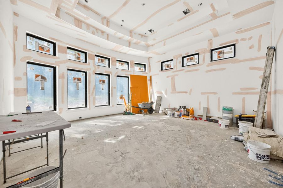 Primary bedroom with an abundance of natural light and 14' ceiling.