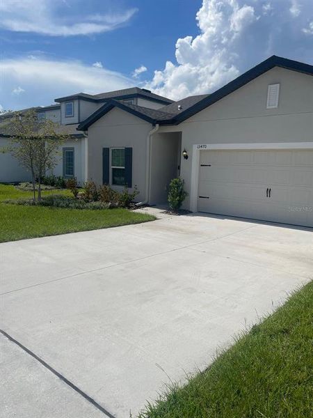 Front exterior of a new home in , Astatula, FL, highlighting curb appeal (Image 2). Front exterior of a new home in , Astatula, FL, highlighting curb appeal (Image 2).