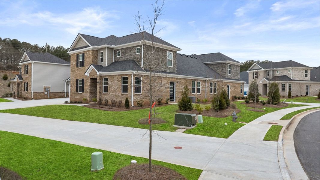 Front exterior of a new home in Independence Villas and Townhomes, Loganville, GA, highlighting curb appeal (Image 19). Front exterior of a new home in Independence Villas and Townhomes, Loganville, GA, highlighting curb appeal (Image 19).