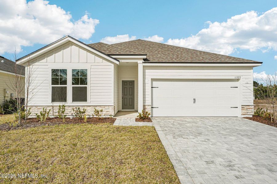 Front exterior of a new home in Panther Creek, Jacksonville, FL, highlighting curb appeal (Image 17).