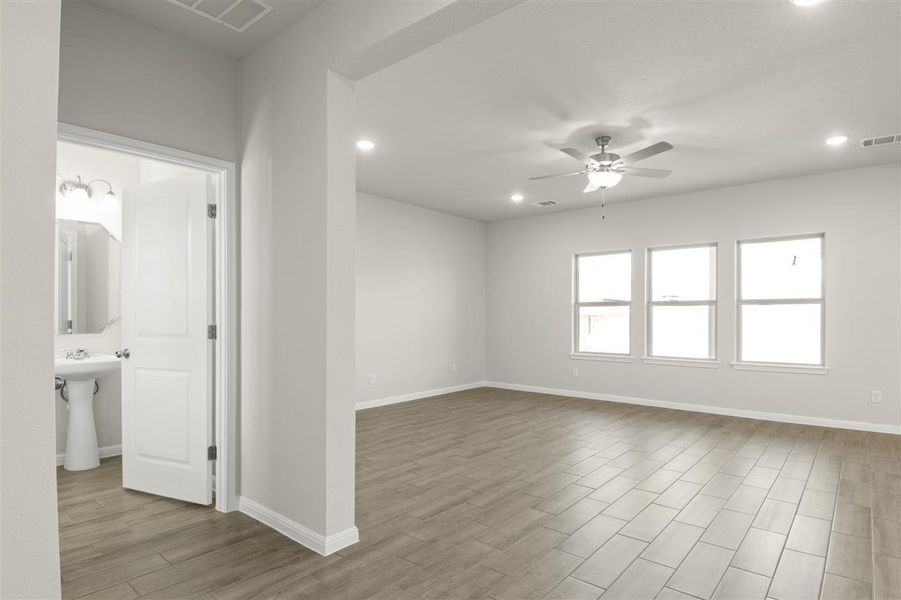 Unfurnished room with visible vents, baseboards, a ceiling fan, and wood finished floors Unfurnished room with visible vents, baseboards, a ceiling fan, and wood finished floors