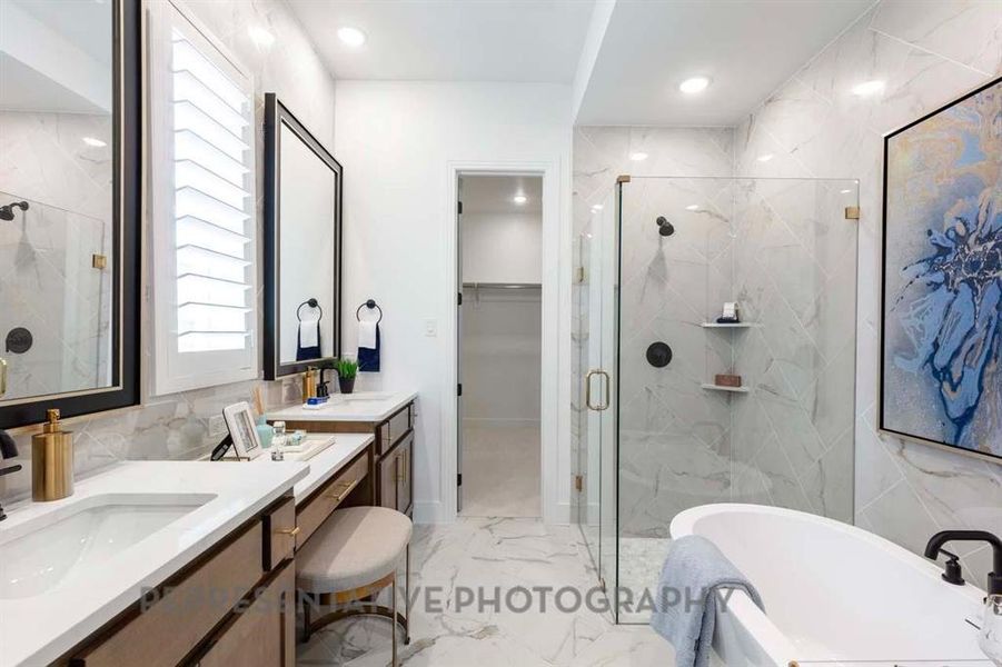 Full bathroom featuring a marble finish shower, light marble finish flooring, a soaking tub, vanity, and recessed lighting Full bathroom featuring a marble finish shower, light marble finish flooring, a soaking tub, vanity, and recessed lighting