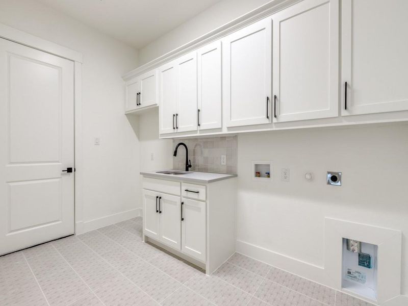 You'll be doing laundry in style in this over the top laundry room!