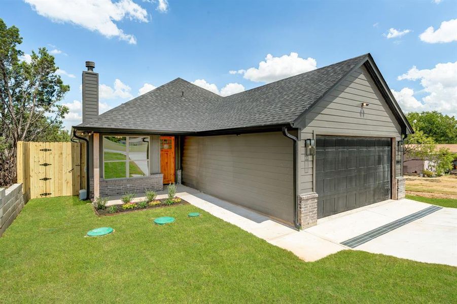 View of front of home featuring a garage and a front yard