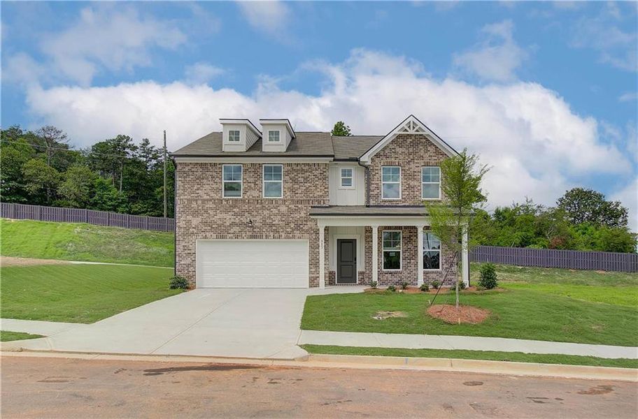 Front exterior of a new home in Kingsmere Estates, Loganville, GA, highlighting curb appeal (Image 1).