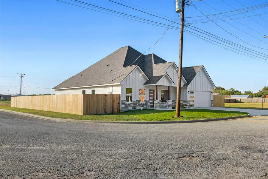 View of front facade featuring a shingled roof, board and batten siding, and driveway View of front facade featuring a shingled roof, board and batten siding, and driveway
