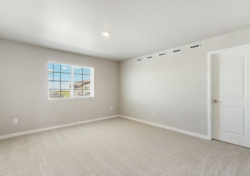 The master bedroom is spacious with a large window.