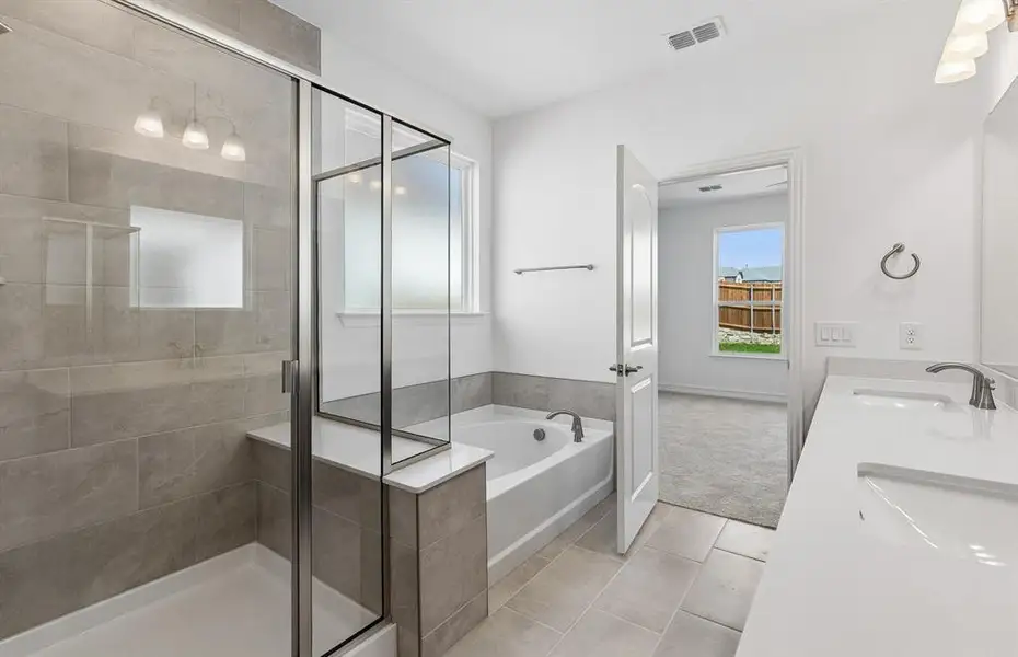 Primary bathroom with separate tub and shower