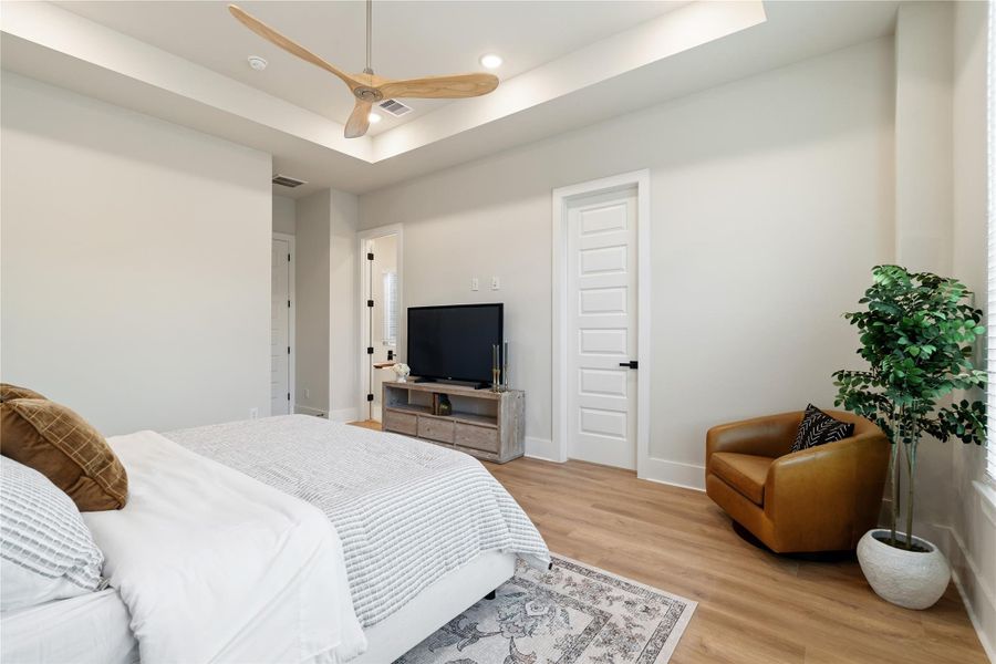 Volume and light define the primary suite, where tray ceilings and expansive windows enhance both scale and atmosphere. His and her closets add a layer of everyday convenience. Volume and light define the primary suite, where tray ceilings and expansive windows enhance both scale and atmosphere. His and her closets add a layer of everyday convenience.