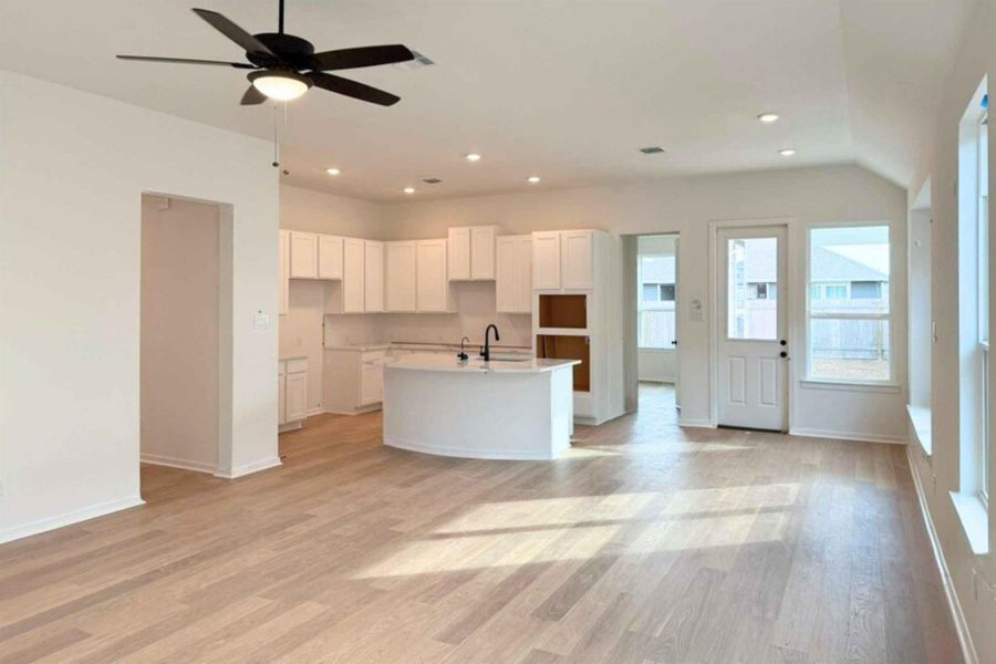Kitchen featuring white cabinets, recessed lighting, light wood-type flooring, an island with sink, and ceiling fan
