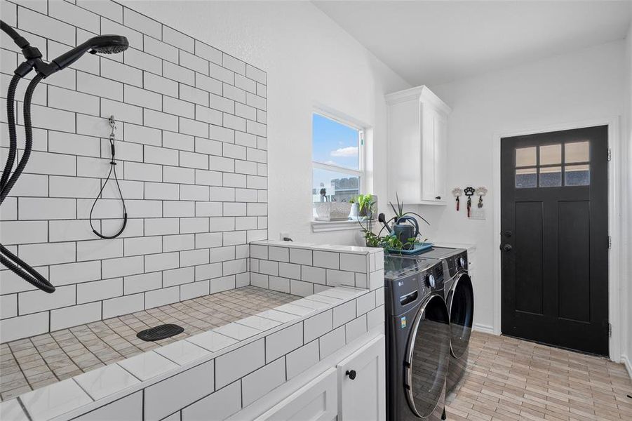 Laundry room with independent washer and dryer and cabinet space
