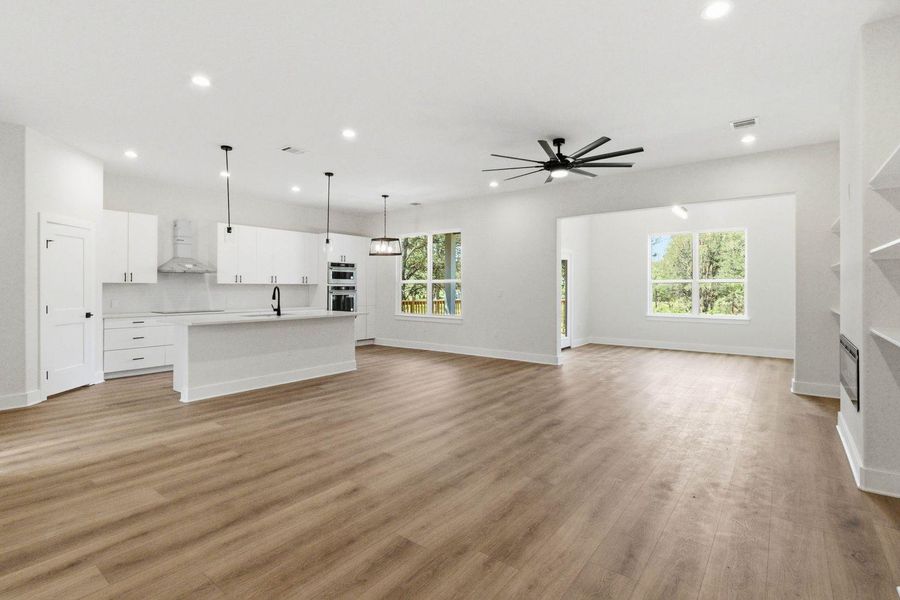 An open concept living space features a modern kitchen and abundant natural light. An open concept living space features a modern kitchen and abundant natural light.