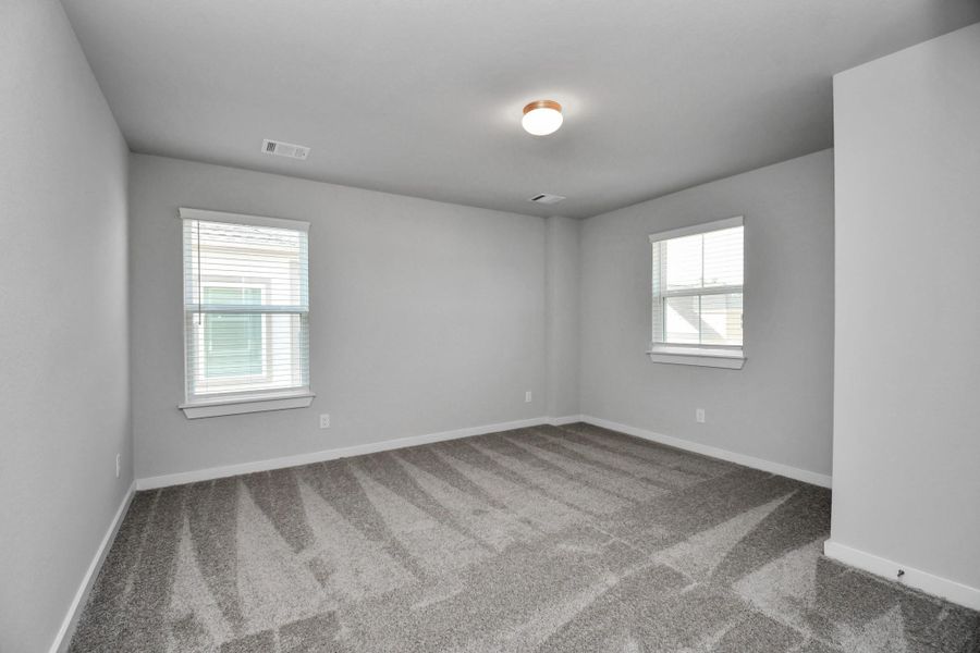 Secondary bedroom features plush carpeting, large windows that let in plenty of natural light, bright paint, and spacious closets. Secondary bedroom features plush carpeting, large windows that let in plenty of natural light, bright paint, and spacious closets.