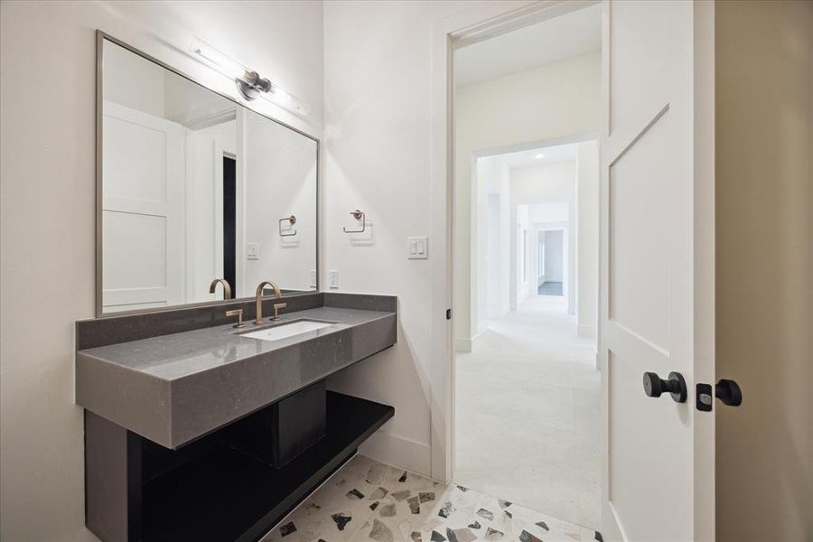 A conveniently located half bath next to the living room overlooks the hallway leading to the bedrooms, blending practicality with thoughtful design.