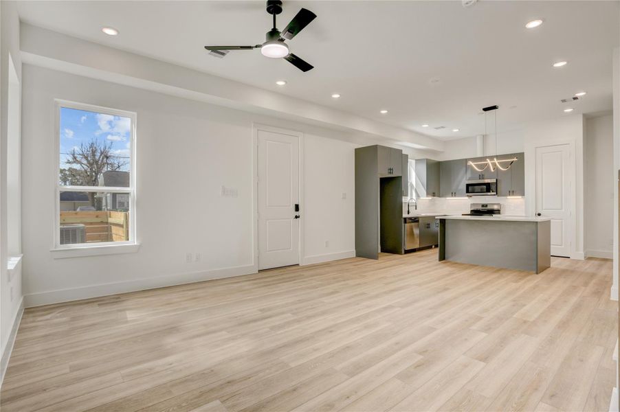 The 10x14 SF living room has a black Hunter fan. Double-glazed windows with Argon gas ensure superior insulation and reduced energy costs throughout the home.