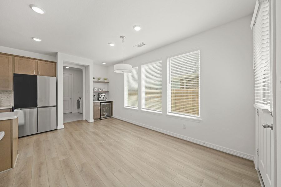 A spacious Breakfast/Dining area is located adjacent to the Kitchen and features a custom coffee bar.