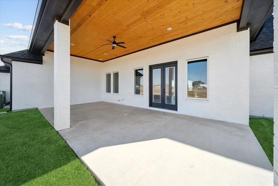 View of patio / terrace featuring french doors, ceiling fan, and central AC unit