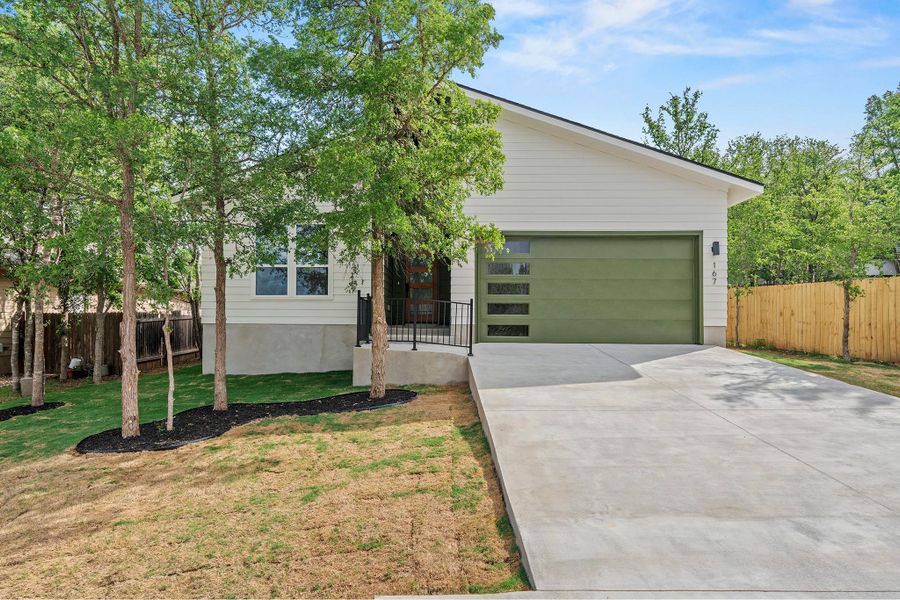 View of front of home featuring concrete driveway and a garage