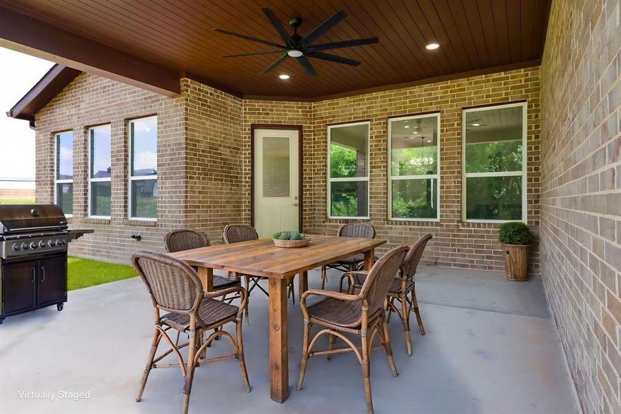 Covered patio featuring a wood-plank ceiling, recessed lighting, and a large ceiling fan Covered patio featuring a wood-plank ceiling, recessed lighting, and a large ceiling fan