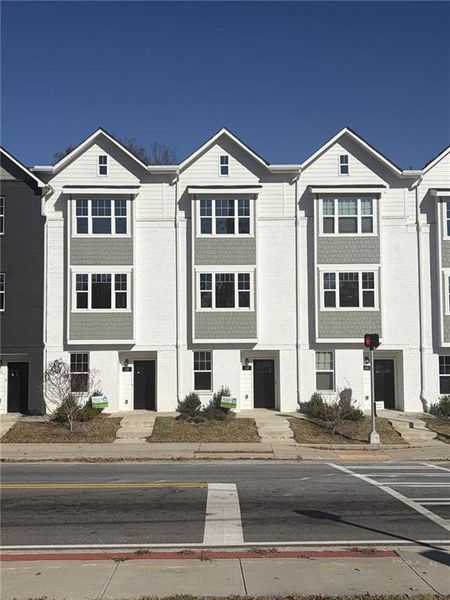 Front exterior of a new home in Three Points at Chosewood Park, Atlanta, GA, highlighting curb appeal (Image 1). Front exterior of a new home in Three Points at Chosewood Park, Atlanta, GA, highlighting curb appeal (Image 1).