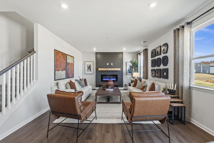 A living room with a large staircase.